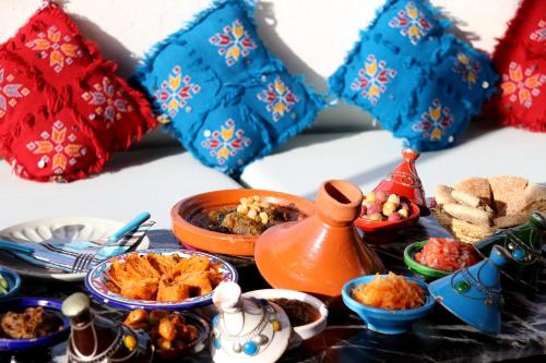 a table topped with bowls and plates of food at Dar Zerhoune in Moulay Idriss Zerhoun