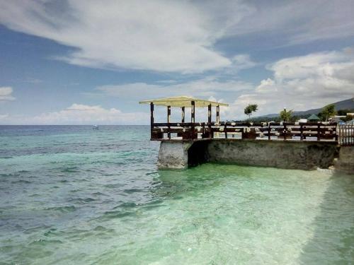 a pier in the ocean with the water at GingGing Hotel And Resort in Oslob