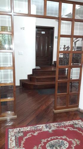 a room with a door and a rug on the floor at Hostal Santa María Gracia in Quito