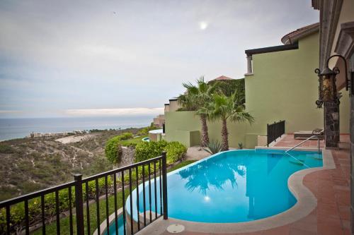 a villa with a swimming pool and the ocean at Montecristo Villas at Quivira Los Cabos -Vacation Rentals in Cabo San Lucas
