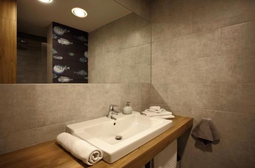 a bathroom with a white sink and a mirror at Gateway Budapest City Center in Budapest