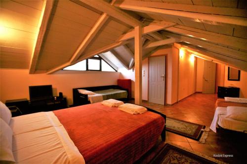 a bedroom with a large bed in a attic at Elikonio in Agia Anna