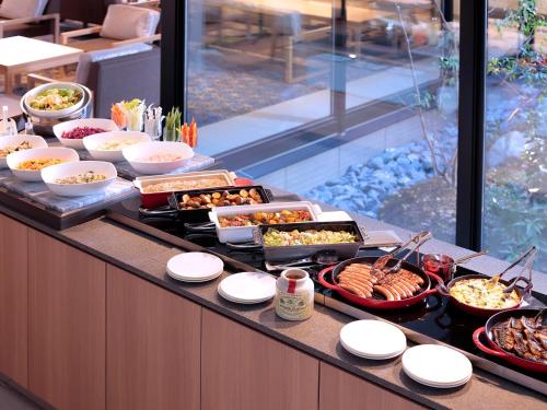 a buffet line with many different types of food at Hotel Intergate Kyoto Shijo Shinmachi in Kyoto