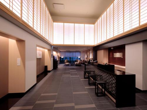 a hallway with benches and a large skylight in a building at Hotel Intergate Kyoto Shijo Shinmachi in Kyoto