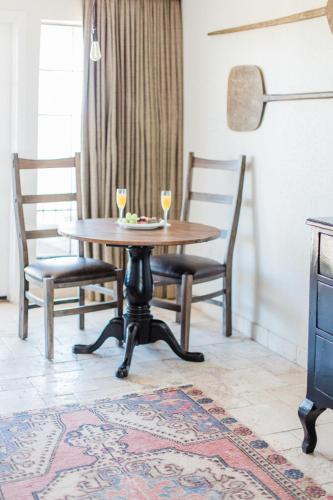 a dining room table with two wine glasses on it at Hillside Boutique Hotel in Castroville