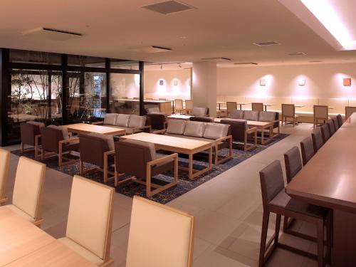 a dining room with tables and chairs at Hotel Intergate Kyoto Shijo Shinmachi in Kyoto