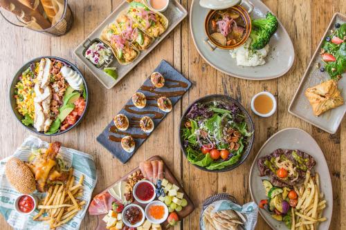 a wooden table with plates of food on it at Hillside Boutique Hotel in Castroville