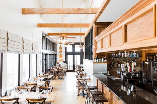 a restaurant with tables and chairs and a bar at Hillside Boutique Hotel in Castroville