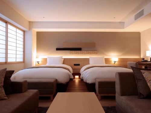 מיטה או מיטות בחדר ב-Hotel Intergate Kyoto Shijo Shinmachi