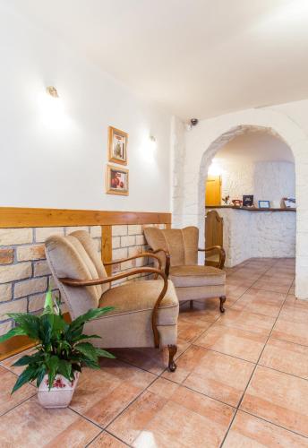 a living room with two chairs and a couch at Villa Cynamon Jacuzzi & Sauna in Wisła