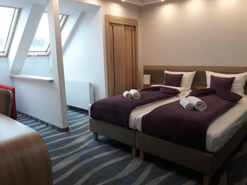 a bedroom with a large bed with pillows on it at Hotel Bardo in Bardo