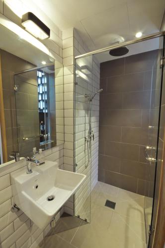 a bathroom with a sink and a shower at The Nest House in Melaka