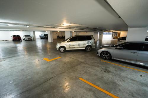 a parking garage with two cars parked in it at Sanae' Townhouse Chiang Mai in Chiang Mai