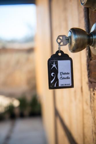 a lock on a door with a sign on it at Quinta Estrella in Valle de Guadalupe