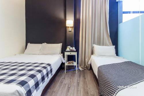 Postel nebo postele na pokoji v ubytování Ceria Hotel