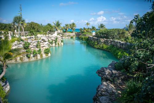 a pool of water in a river with trees at Hotel Xcaret Mexico All Parks All Fun Inclusive in Playa del Carmen
