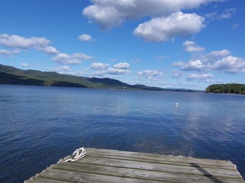 a dock on a large body of water at Breathtaking New Premier Lake Champlain Waterfront Escape! in Addison