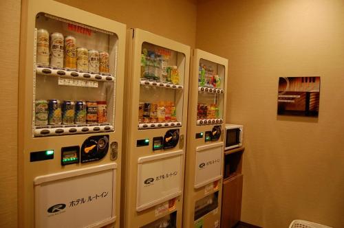 two vending machines in a room with drinks at Hotel Route-Inn Sendai Higashi in Sendai