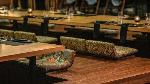 a row of tables and chairs in a restaurant at Hotel Xcaret Mexico All Parks All Fun Inclusive in Playa del Carmen