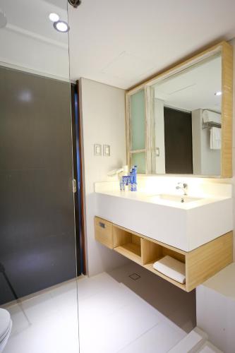 a bathroom with a sink and a shower at TRYP by Wyndham Mall of Asia Manila in Manila