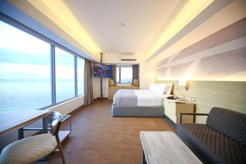 a hotel room with a bed and a large window at TRYP by Wyndham Mall of Asia Manila in Manila