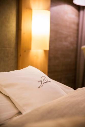 a tattoo on the side of a bed at Hotel Annelies in Ramsau am Dachstein