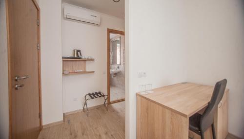 a small room with a wooden table and a door at Biplan Hotel in Daugavpils