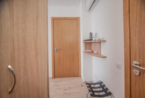 a room with a wooden door and a chair at Biplan Hotel in Daugavpils
