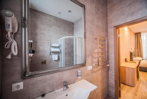 a bathroom with a sink and a mirror at Biplan Hotel in Daugavpils