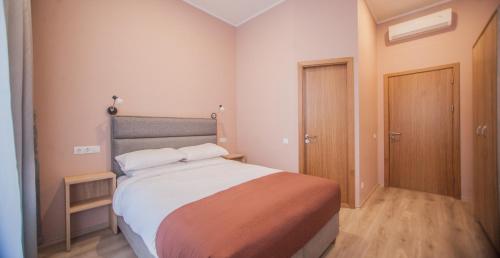 a bedroom with a large bed in a room at Biplan Hotel in Daugavpils