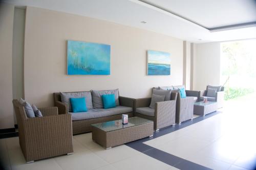 a living room with couches and a table at Sunshine Apartment in 5* resort in Da Nang