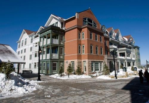 a large brick building with snow around it at Seneca - Snowshoe in Snowshoe