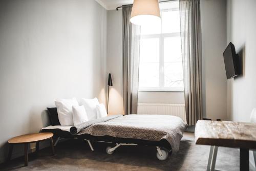 a bedroom with a bed and a window at Hotel city.city in Ostrava