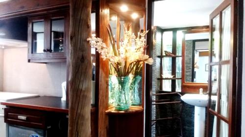 a vase of flowers on a counter in a room at The Dream Home Villas in Denpasar