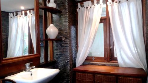a bathroom with a sink and two windows at The Dream Home Villas in Denpasar