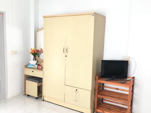a white cabinet with a television in a room at MP House in Ban Rong Khoei