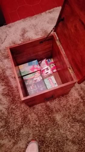 a wooden box on the floor with books in it at Casa da tia Bina in Monsaraz