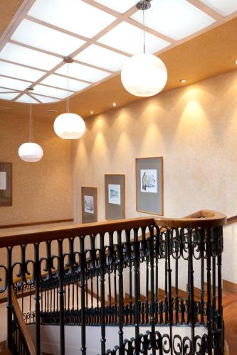 a staircase in a building with lights on the wall at Victoria 4 Puerta del Sol in Madrid