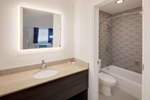 a bathroom with a sink and a toilet and a tub at Howard Johnson by Wyndham Florence in Florence