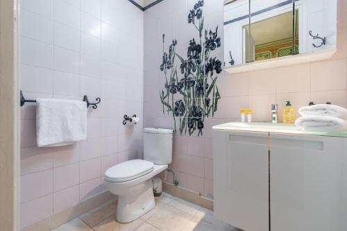 a white bathroom with a toilet and a sink at Villa COLLIN - Promenade des Anglais in Nice