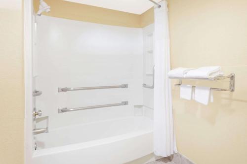 a bathroom with a shower with white towels at Regency Inn & Suites-Hamilton Place in Chattanooga