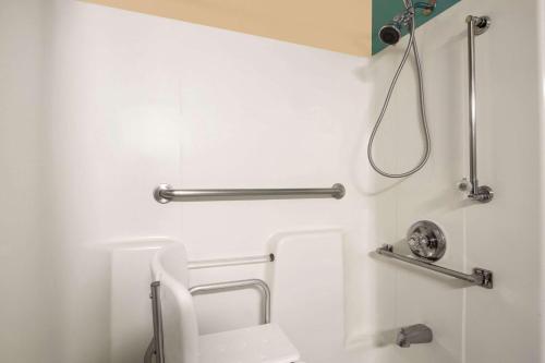 a bathroom with a toilet and a shower at Super 8 by Wyndham Peoria East in Peoria
