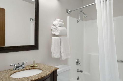 a bathroom with a white towel hanging on the wall at Super 8 by Wyndham Washington in Washington