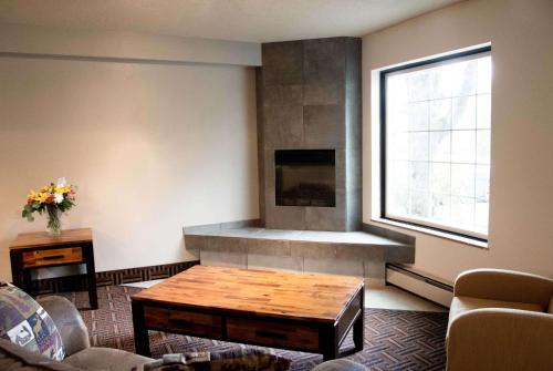a living room with a fireplace and a coffee table at Super 8 by Wyndham Juneau in Juneau