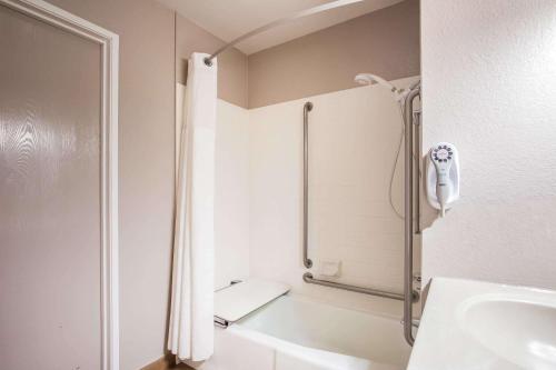 a bathroom with a shower and a sink at Super 8 by Wyndham Vacaville in Vacaville