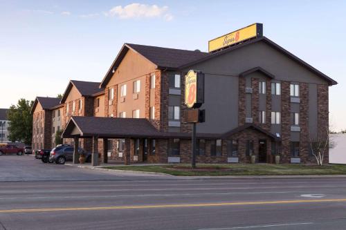 a large building on the corner of a street at Super 8 by Wyndham Sioux Falls/41st Street in Sioux Falls