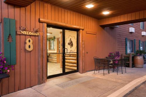 a door to a house with a welcome eight sign on it at Super 8 by Wyndham Jackson Hole in Jackson