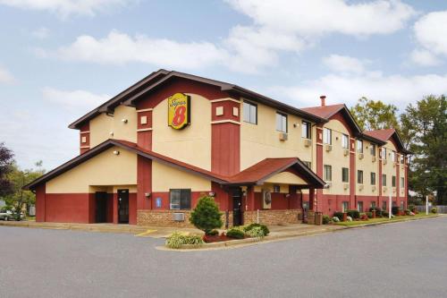 a building with a sign on the side of it at Super 8 by Wyndham Richmond Airport VA in Richmond