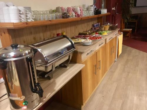 a kitchen with a buffet of food on the counters at Penzion Partizan in Smokovce