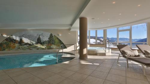 a living room with a swimming pool in a house at Hotel Lärchenhof in Maranza